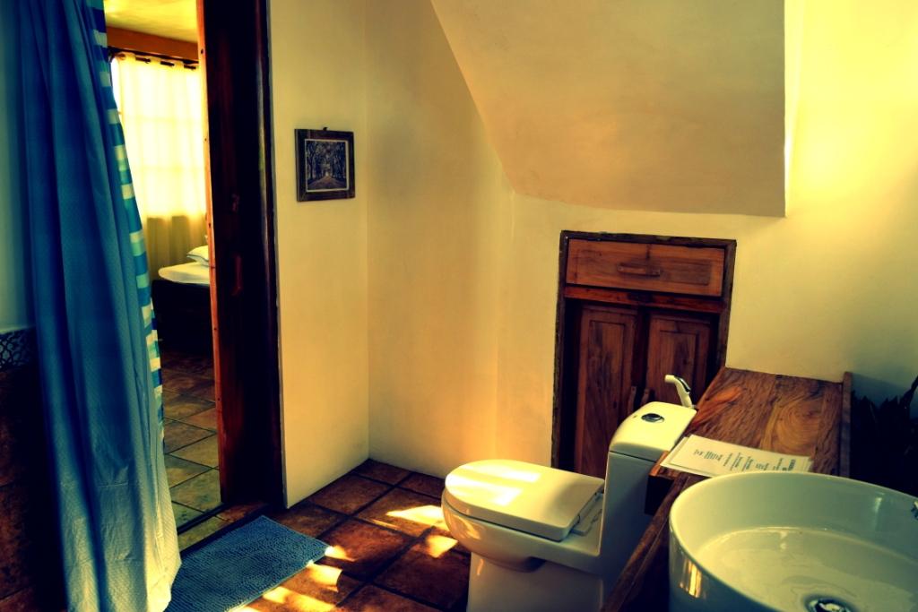 generous bathroom with hand built hardwood features and spanish tiles